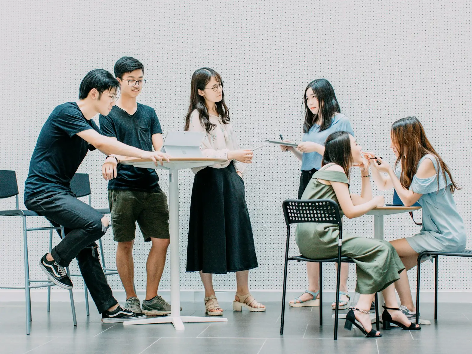 two men and four women meeting in office