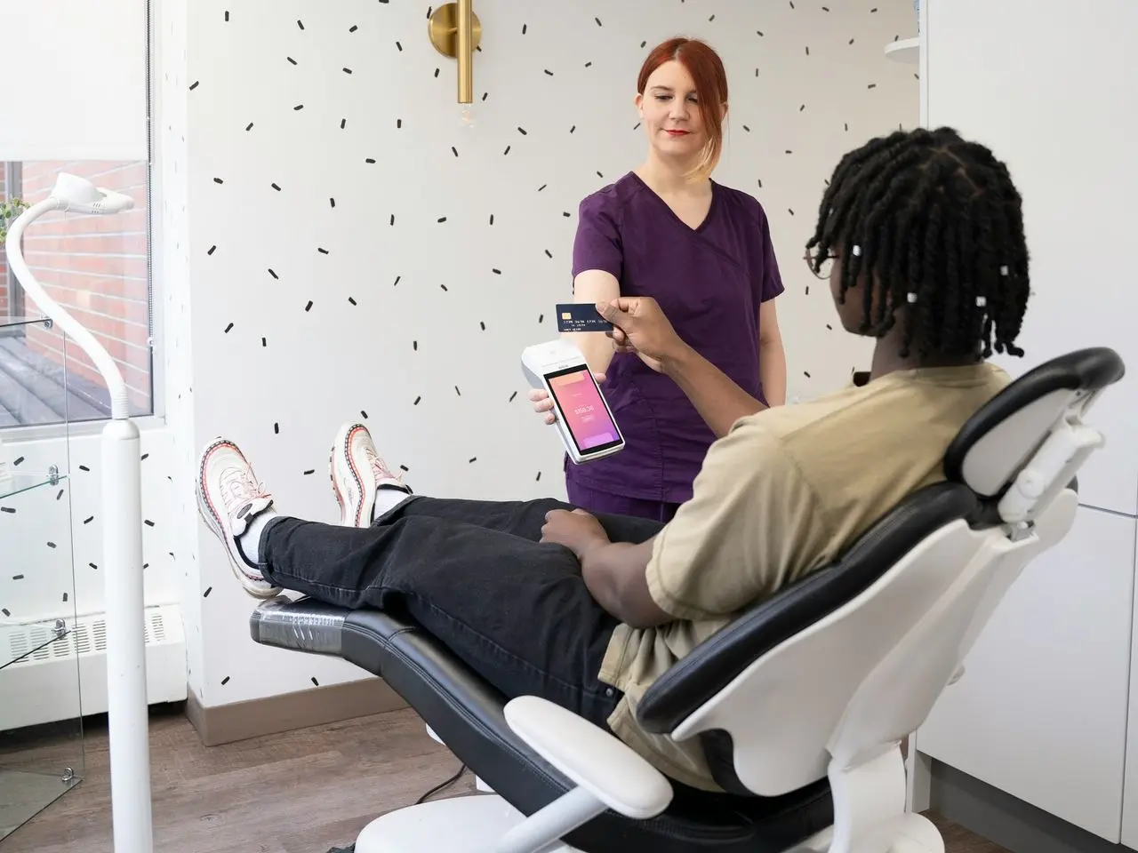 a woman sitting in a chair with a tablet