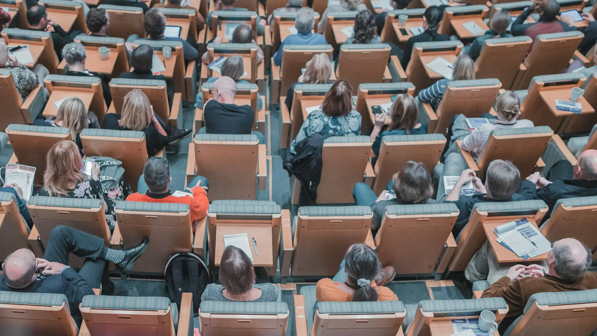 high-angle photography of group of people sitting at chairs